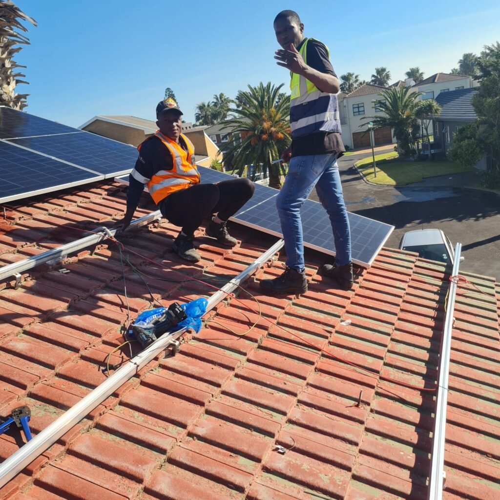 Gracelight team on roof installing solar panels